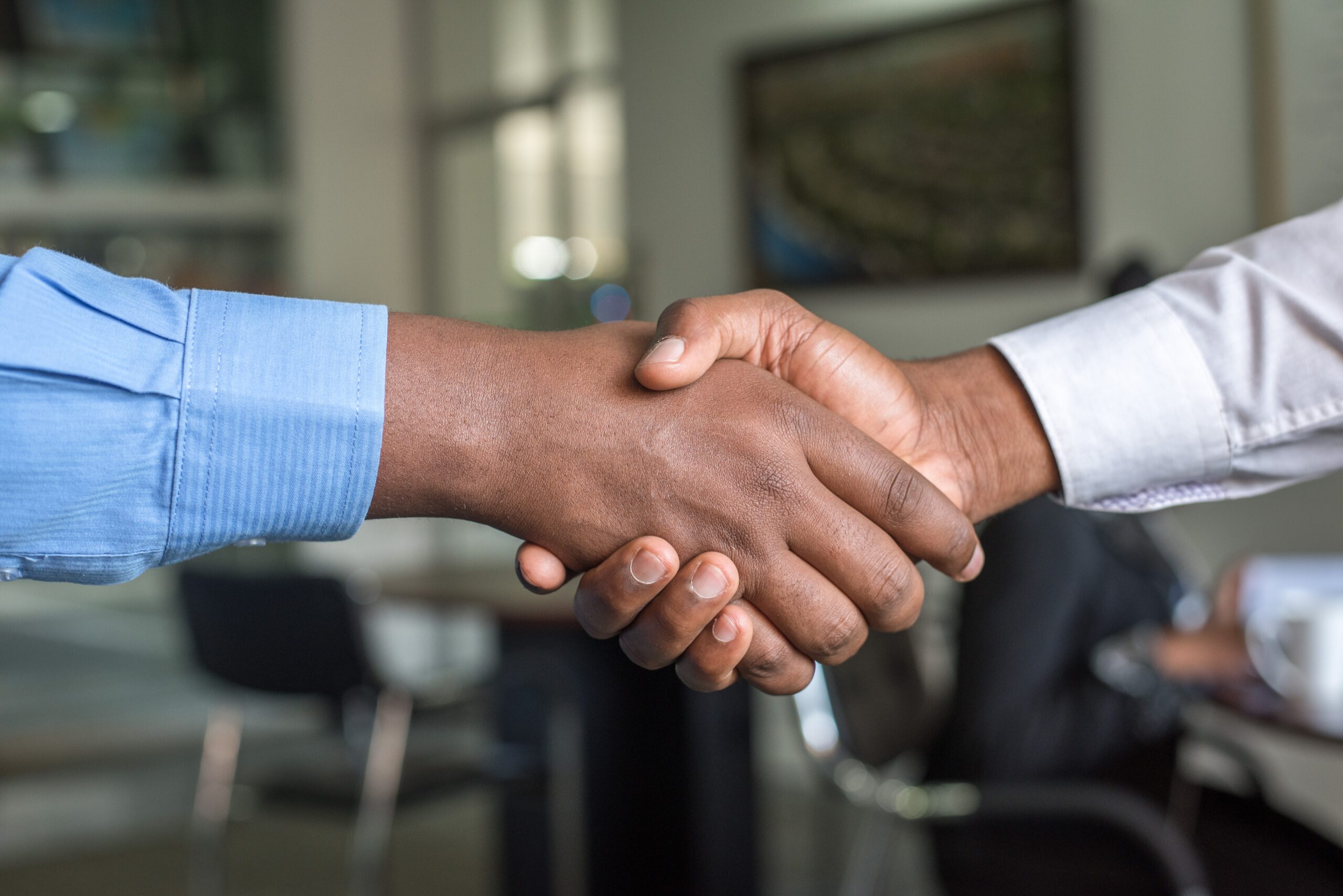 Two people shaking hands for why we do face to face meetings