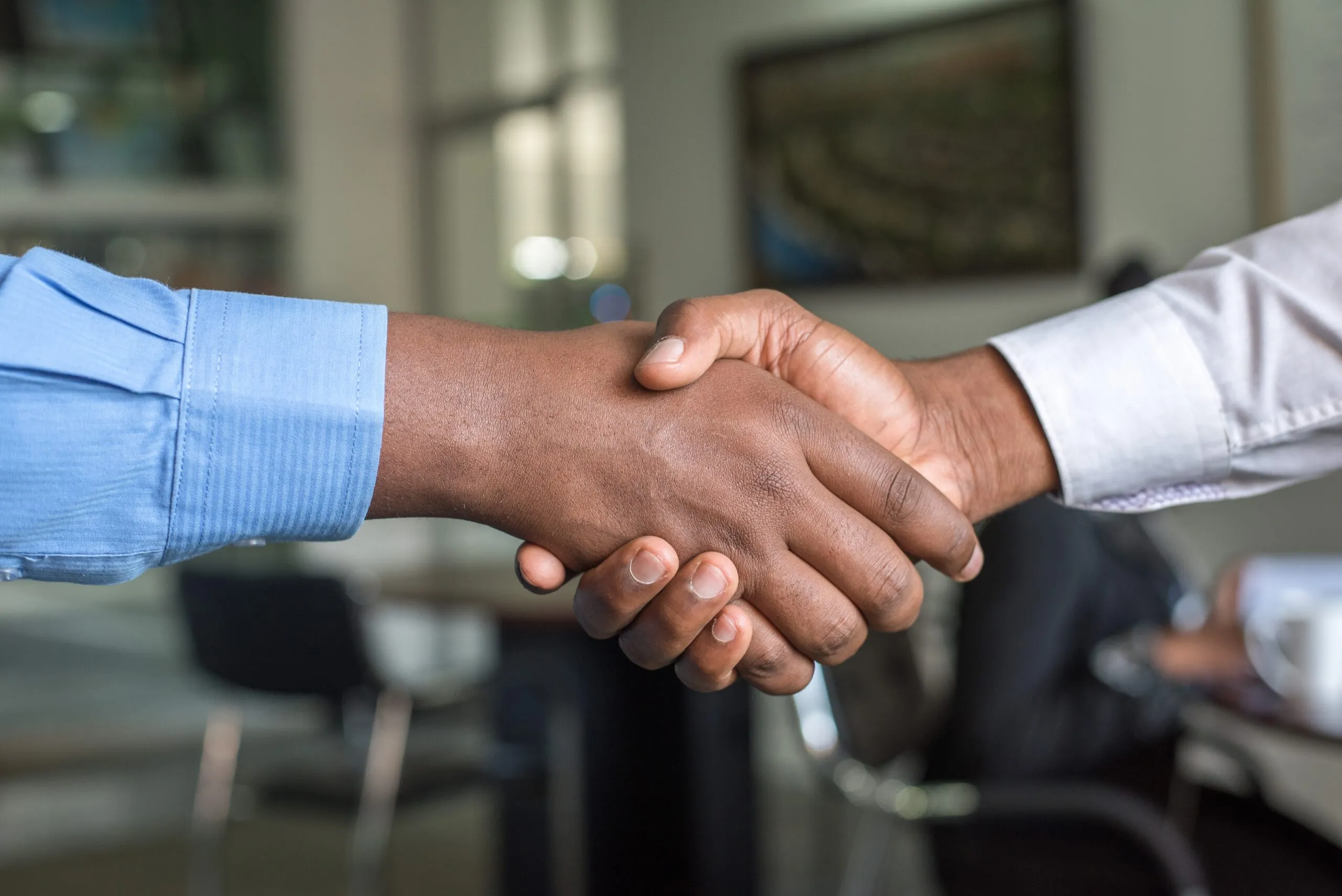 Two people shaking hands for why we do face to face meetings
